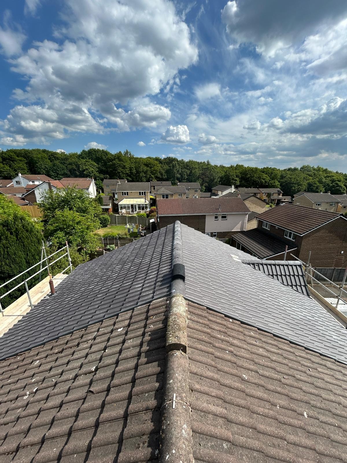 Finished pitched roof re-tile viewed along the ridge on a bright day